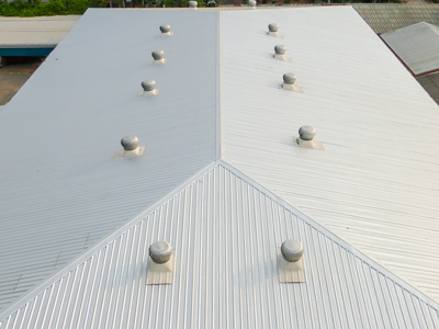 Looking down at a commercial building with a white metal roof