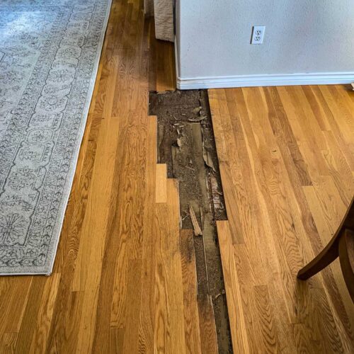 Wooden flooring in a living room in need of repair