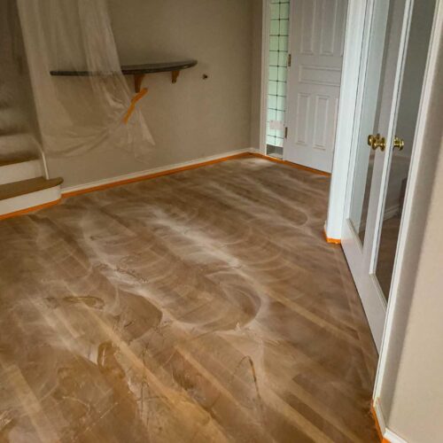 Dusty wooden floors in the interior entrance of a house