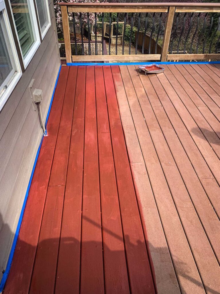 Wooden deck being stained a red color