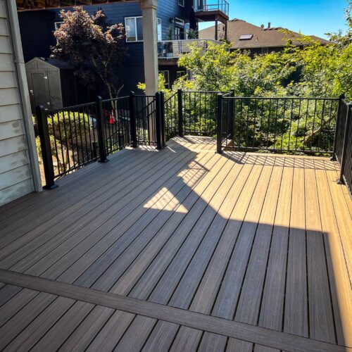 Large back deck with composite decking and metal hand rails