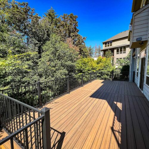 Large back deck with composite decking and metal hand rails