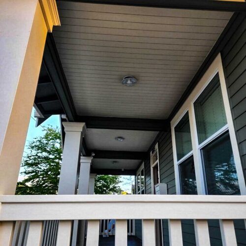 White deck railing on a dark colored master craft home