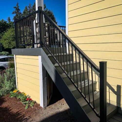 Stairway with composite decking on a yellow house