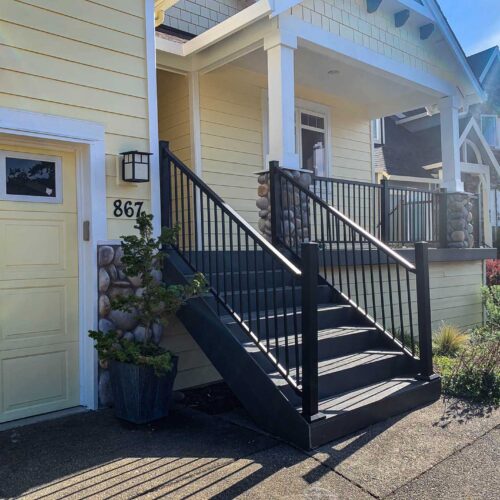 Composite deck stairway on a yellow house