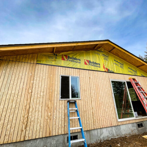 Wooden siding being put on a new construction house