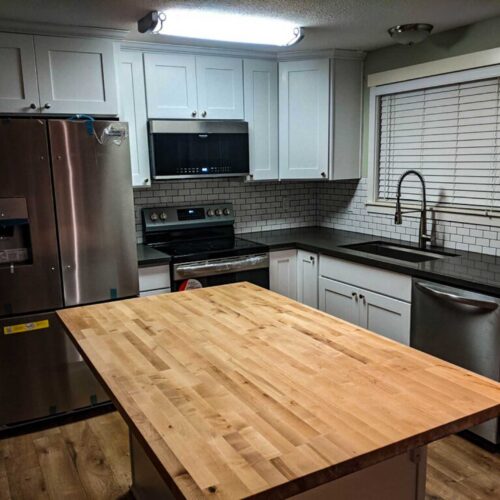 Wooden kitchen island in a modern kitchen with new appliances