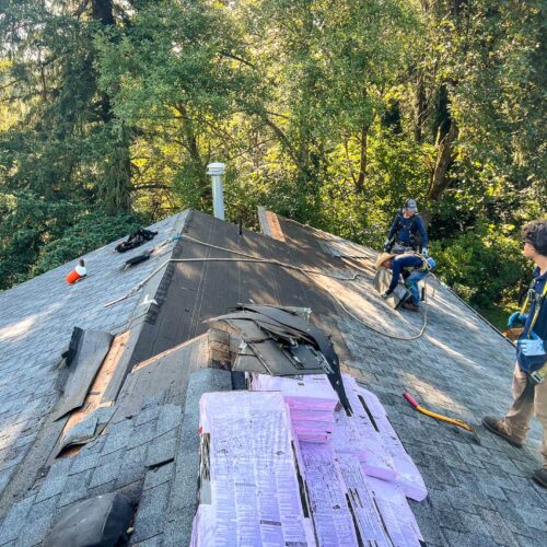 American Mastercraft workers replacing a section of a roof.