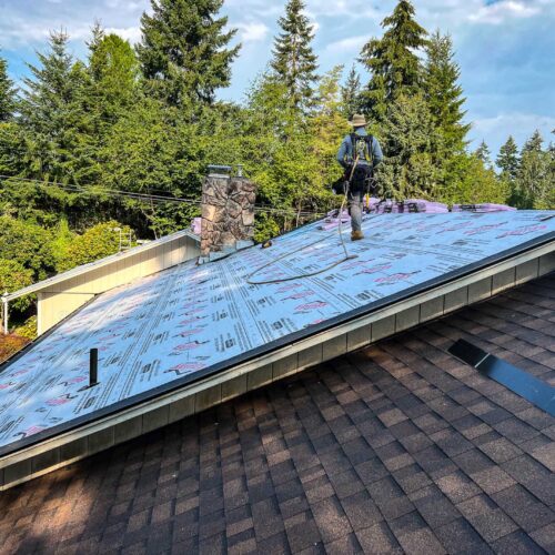 American Mastercraft worker replacing a section of a roof.