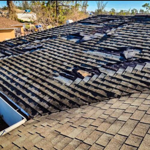 damaged roof shingles in need of a repair on a old roof