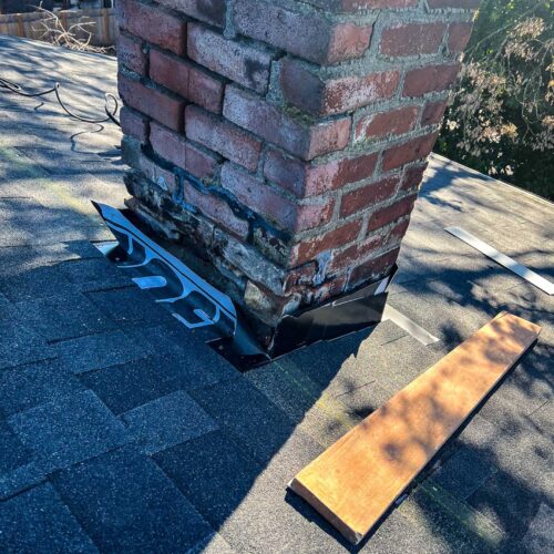 Old chimney on a shingled roof