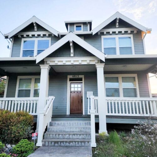 Dark green colored Craftsman style home