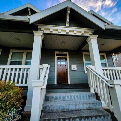 Dark green colored Craftsman style home