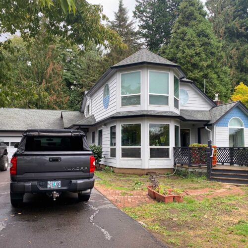 dark grey Toyota Tundra in the driveway of a two story home