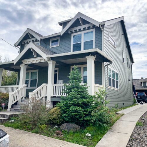 Dark green colored Craftsman style home