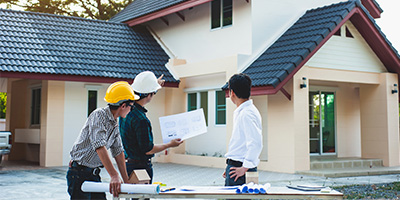 Roofing contractor going over roof project with customer