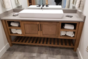 closeup of new bamboo bathroom vanity with a new countertop and white sink from a bathroom remodel